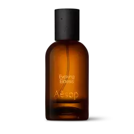 Amber glass Aesop Evoking Eidesis Eau de Parfum bottle with black cap on a white background.